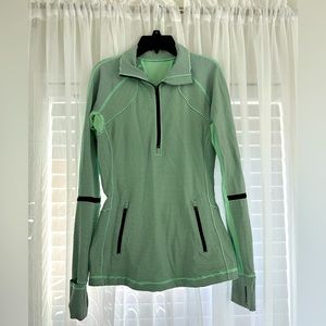 Lululemon fitted half zip up with front pocket and thumb holes. Mint green color